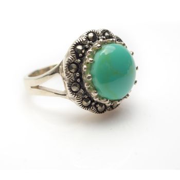 Sterling silver round turquoise cabachon ring with marcasite.  Isolated on white background with light shadow