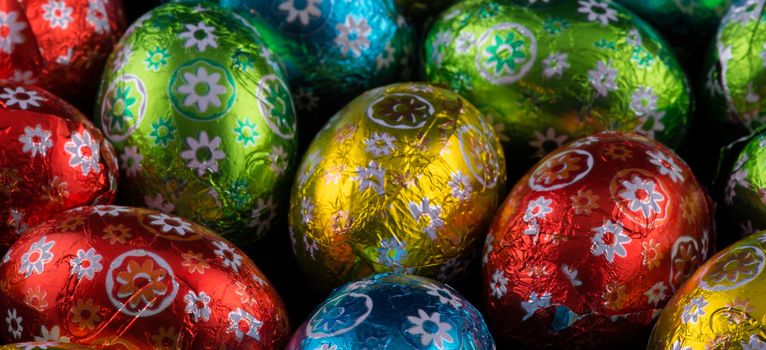 Beautiful colorful tiny Easter Eggs on black background.