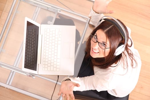 Cheerful business woman working on a Laptop.