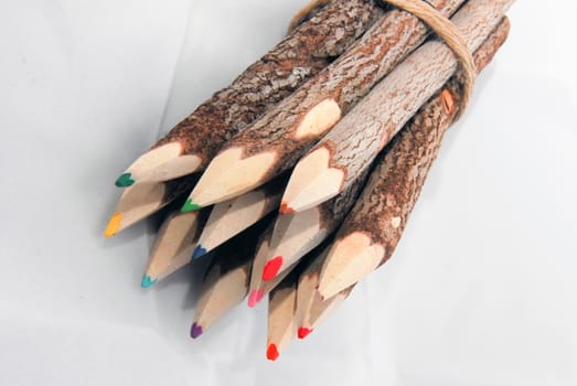 Sharpened multi colored pencils on white background