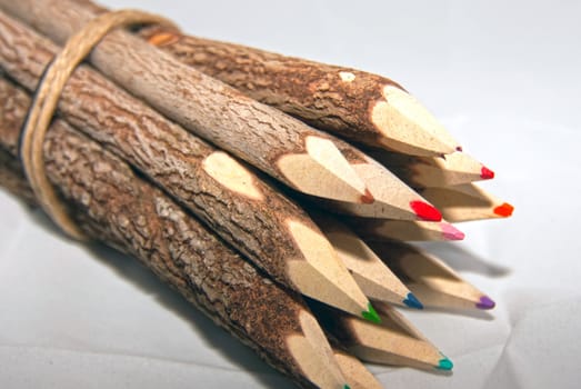 Sharpened multi colored pencils on white background