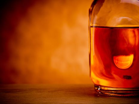 Bottle of whiskey on grunge background