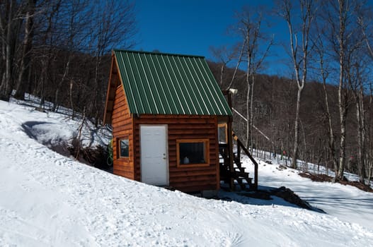 mini log cabin in mountain forest  with snow