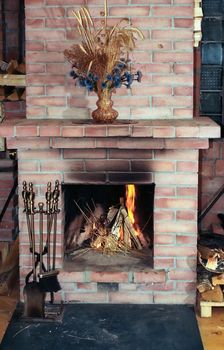 Village house fireplace with vase on  mantelshelf