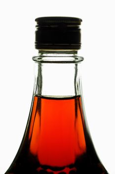 Bottle with maple syrup back lighted (vertical). Can be wine, liquor, etc.