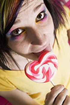 Close-up of an Alternative Girl with a Heart Lollipop