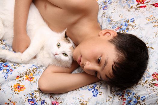 asian boy with cat lieng in bed