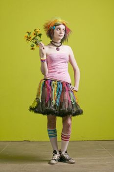 Pretty young woman with colorful punk clothes with plastic flowers.