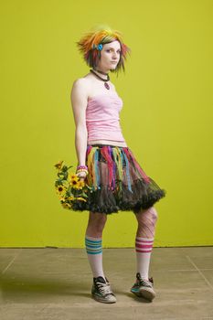 Pretty young woman with colorful punk clothes with plastic flowers.