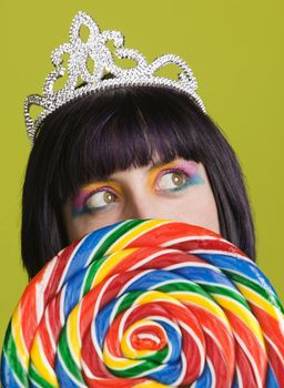 Pretty young woman with a large colorful lollipop
