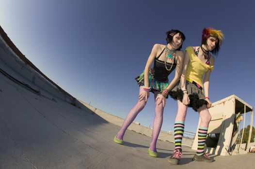 Fisheye shot of girls in brightly colored clothing on a roof