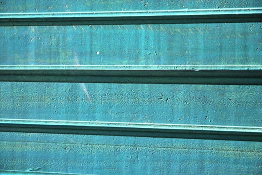 green wooden boards with paint that was peeling and faded