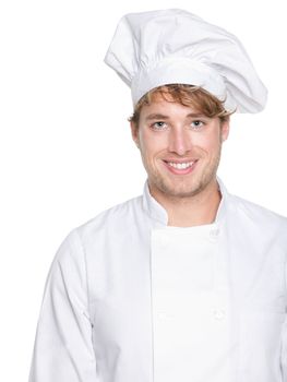 Chef, baker or male cook. Young man in chefs whites uniform smiling happy at camera. Portrait of young chef in his twenties.