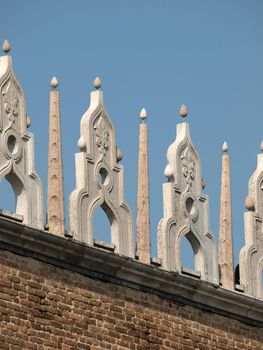 Characteristic architectural ornaments on the edge of a roof of the Doges' Palace in Venice