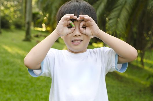 Little Asian boy having fun at outdoor park