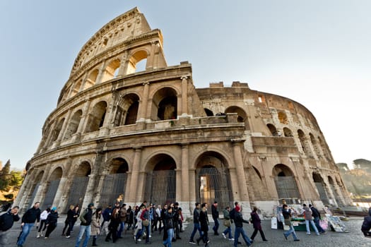 People walking around the Colosseum in Rome, Italy