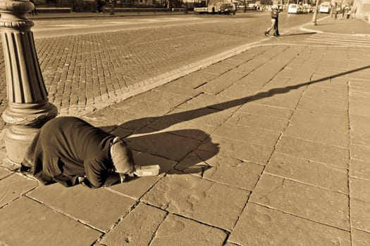 A woman panhandler begging for money on the streets of Rome