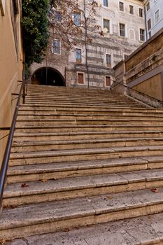 A steep marble staircase leading to an old building in Rome, Italy