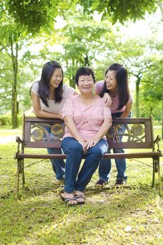 Happy Asian senior mother with her daughters