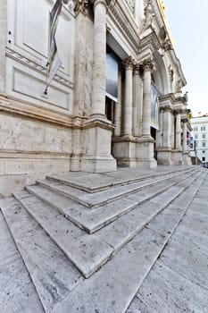 Marble stairs leading to the entrance of an old building