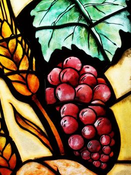 Detail of a grapes glass in church