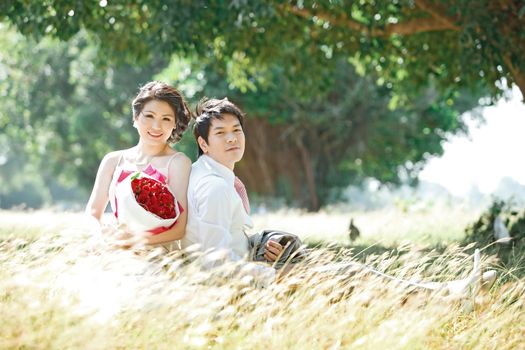 couples outdoors on windy grass