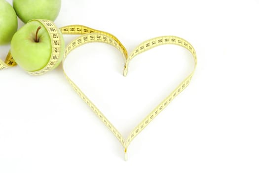green apple with a measuring tape and heart symbol isolated on white background 