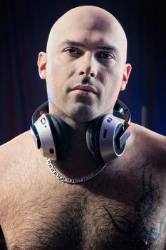 Torso of a man in wearing headphones. Studio-style portrait