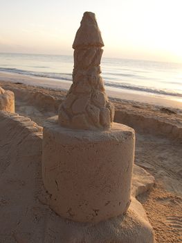 close-up view of a sand castle tower at sunrise