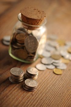 old coins on the wooden table, shallow dof