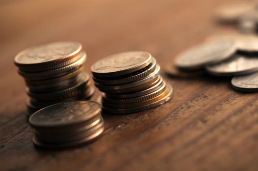 old coins on the wooden table, shallow dof