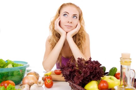 Woman with vegetables at table over white background