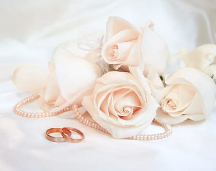 Wedding rings and roses as wedding background 