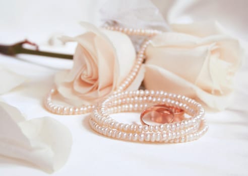 Wedding rings and roses as wedding background 