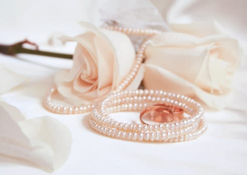 Wedding rings and roses as wedding background 