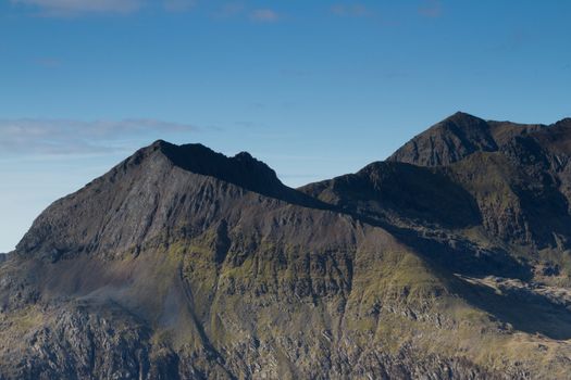 The east face and north ridge of Crib Goch with mount Snowdon in the distance, located in the Snowdonia National Park, Wales, UK.