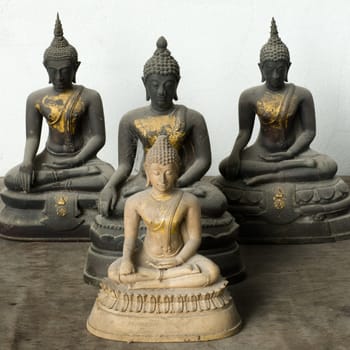 One Old Light Stone Buddha Front and Three Dark statue back