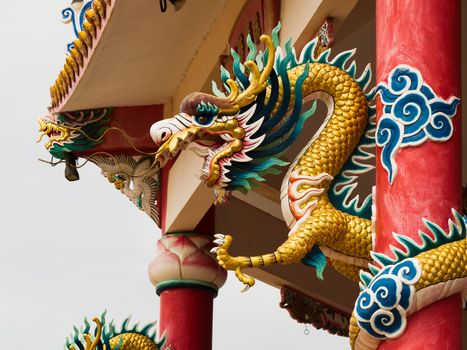 Right Golden dragon statue on red pillar in Chinese Temple style