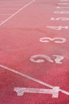 White Number on Red race track floor at start point