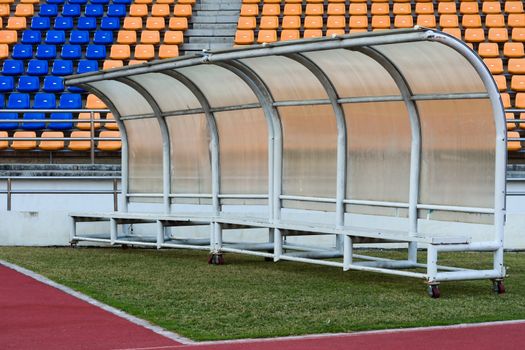 White bench for athletes Inside the stadium on Grass