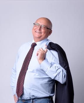 portrait of a successful senior man on gray background