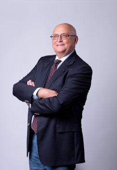 portrait of a successful senior man on gray background