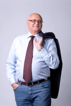 portrait of a successful senior man on gray background