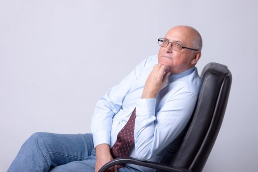 portrait of a successful senior man on gray background