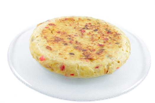 Spanish omelette made ​​with potatoes, eggs, onion, green and red peppers, salt and olive oil, horizontal format with a white background isolated