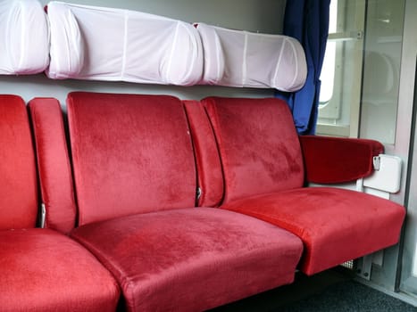 Red chairs in Serbian train