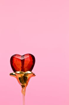 one crystal heart on pink background in portrait orientation for valentine use