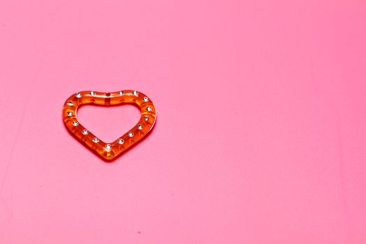 heart shape plastic on pink background in landscape orientation for valentine