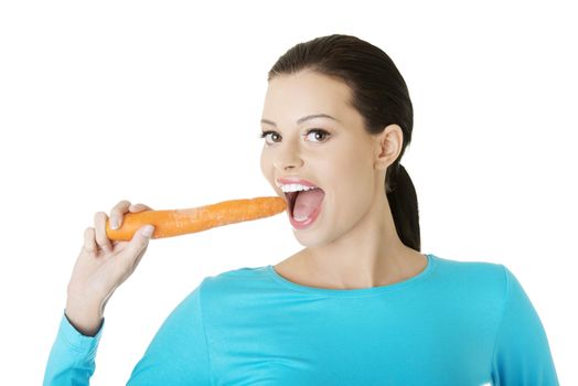 Fit young happy beautiful woman with carrot, isolated on white