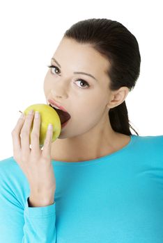 Attractive young woman eating green apple. Isolated on white background